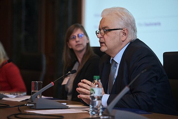 Judge Mykola Gnatovskyy (right) in discussion with Dr Emma Brandon (middle)