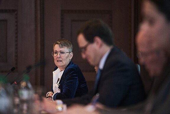Professor Louise Chappell (left) in discussion with Dr Pablo Gavira Díaz (middle)