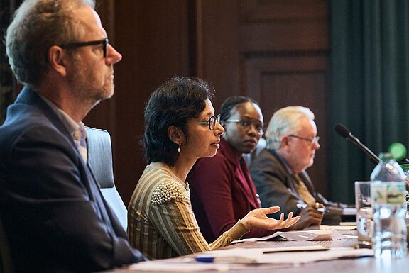 From left to right: Professor Gerry Simpson, Professor Neha Jain, Darleen Seda and Professor William Schabas