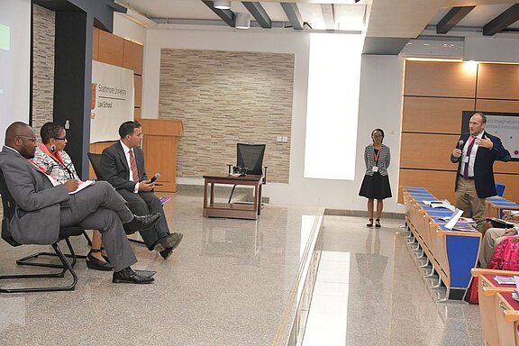 Dr_Philip_Ambach_asking_the_panel_a_question__L-R__Douglas_Gichuki__Justice_Williams_and_Dr_Luis_Franceschi.JPG  