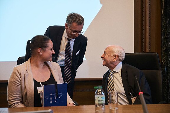Professor Christoph Safferling (middle) in conversation with Rebecca Weiss (left) and Professor Herbert Reginbogin (right)